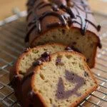 Finished Bolo de Banana com Chocolate with chocolate drizzle and banana slices, perfect for dessert.